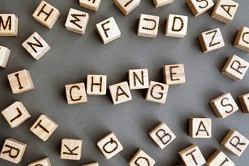 the word change wooden cubes with burnt letters, improvement or worsening of career growth gray...