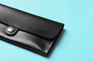Leather wallet on color background, closeup with space for text. Stylish accessory