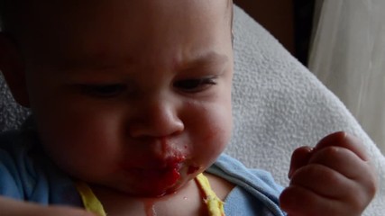 cute seven months old baby doesnt like taste of strawberries