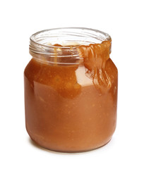 Jar of tasty caramel sauce isolated on white
