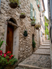 Fototapeta na wymiar small pedestrian street in medieval village of Sainte Agnes in the French Riviera in summer