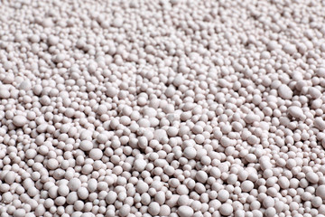 Textured chemical fertilizer for gardening as background, closeup