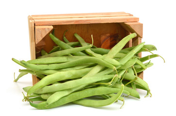 green beans in wooden crate on white background