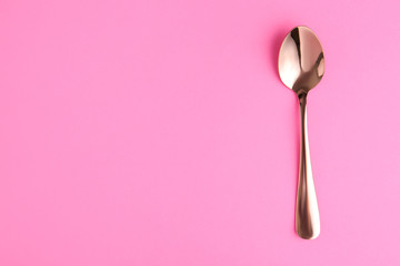 Clean tea spoon and space for text on color background, top view
