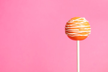 Bright delicious cake pop on color background. Space for text