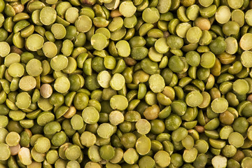 Top view on background texture of uncooked green split peas. Copy space for your text.