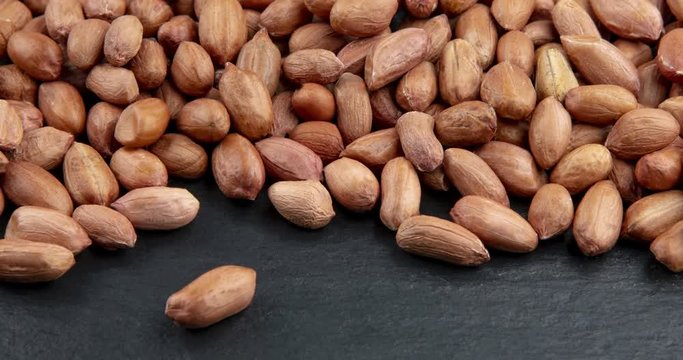 Close up of unpeeled peanuts. Food background