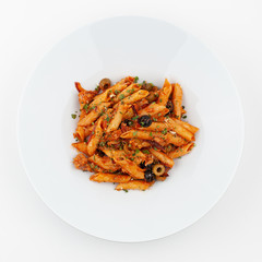 Vegetarian penne arrabiata with olives and tomato sauce on a white studio background