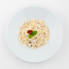 Farfalle carbonara in creamy sauce with parmesan isolated on white background