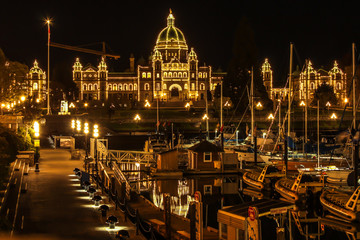 A night time view of the parliament building and harbor of Victoria, British Columbia, Canada.