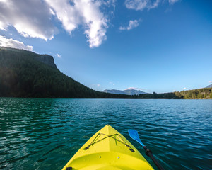 Kayak Boat Point of View on Turquoise Mountain Lake Water