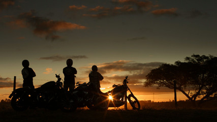 motorcyclists enjoy the sky in late afternoon