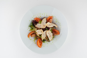Vegan mixed salad with ripe tomatoes, olive oil and croutons on white background