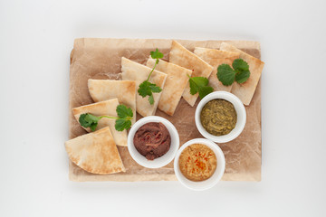 Set of vegan snack: eggplant, lentils and avocado pates with wheat pita
