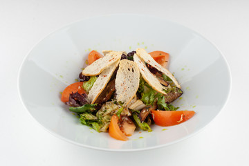 Mixed salad with ripe tomatoes, herbs, olive oil and crunchy croutons for a perfect vegan lunch
