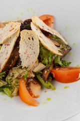 Mixed salad with ripe tomatoes, herbs, olive oil and crunchy croutons for a perfect vegan lunch
