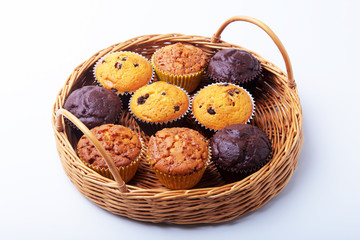 Wicker basket with assorted delicious homemade cupcakes with raisins and chocolate. Cupcakes. Top View. Copy space.