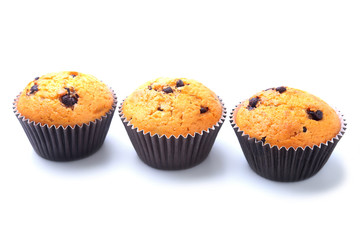Assorted with Delicious homemade cupcakes with raisins and chocolate isolated on white background. Muffins. Top view. Copy space.