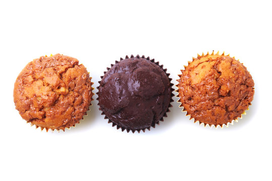 Assorted with Delicious homemade cupcakes with raisins and chocolate isolated on white background. Muffins. Top view.