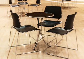 three metal bar chairs and table