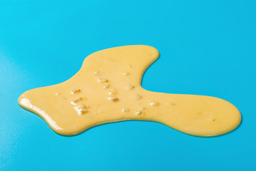 side view mango flavor ice cream melt on blue background