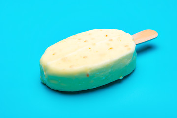 side view fresh popsicle with white chocolate outer on blue background