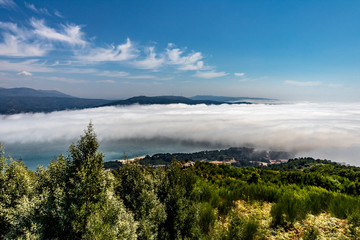 Fototapeta na wymiar landscape with mountains, fog and blue sky