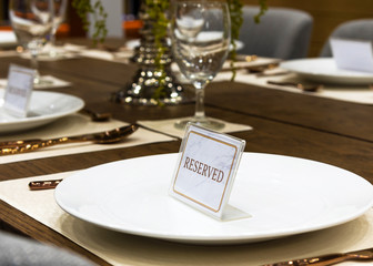 Reservation on a dinner table at the restaurant, plate reserve