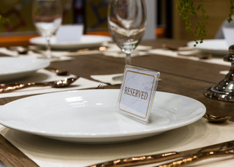 Reservation on a dinner table at the restaurant, plate reserve