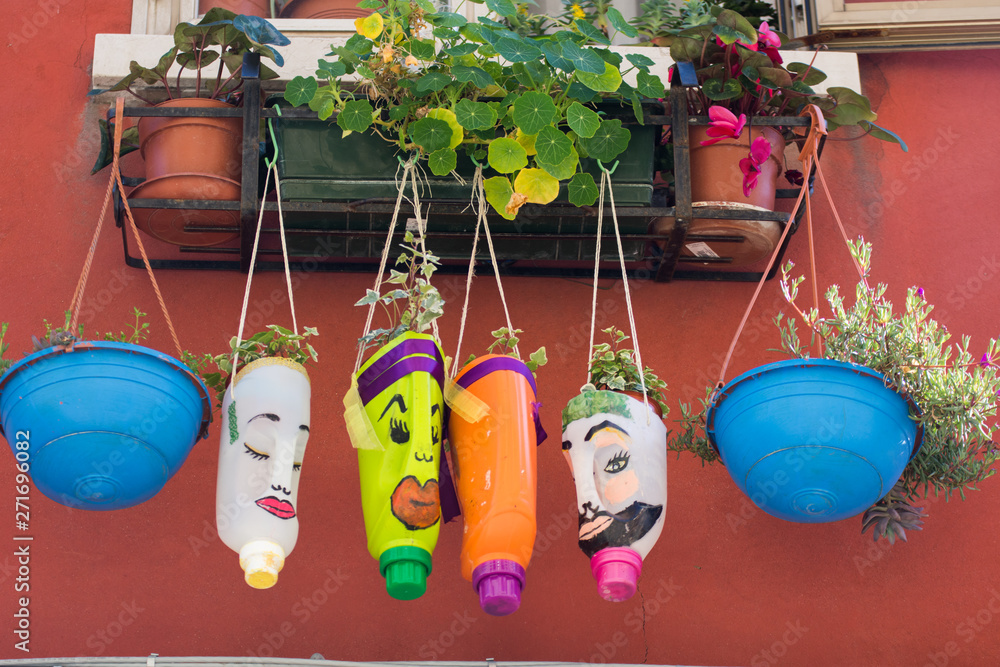 Wall mural funny flowerpot.,flowers in plastic bottles, in Murano, Venice, Italy, 2019