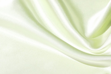 The texture of the satin fabric of green color for the background