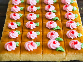 Homemade orange butter cream cake on table.