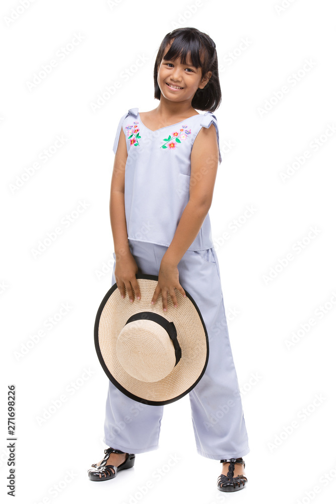 Wall mural Cute little girl standing in swimming wear and hat on white background.