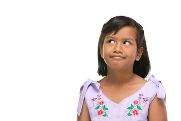 Cute asian dark little girl making a funny emotion on face .