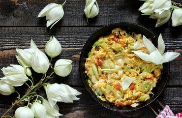 Yucca flowers dish. flower petals fried with eggs and tomatoes. national cuisine of Costa Rica. edible flowers recipe. Yucca is the national flower of Costa Rica