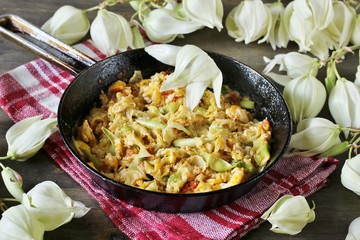 Yucca flowers dish. flower petals fried with eggs and tomatoes. national cuisine of Costa Rica. edible flowers recipe. Yucca is the national flower of Costa Rica