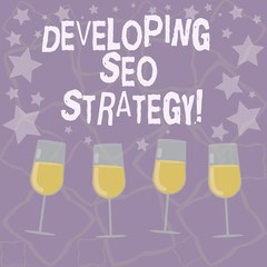 Writing note showing Developing Seo Strategy. Business photo showcasing process of tailoring your website at optimal rank Filled Cocktail Wine Glasses with Scattered Stars as Confetti Stemware