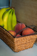 Ripe peaches in a wicker fruit basket