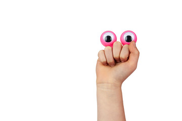 Scared but smiling funny cartoonish face made by googly eyes and childs hand isolated on white background with copy space