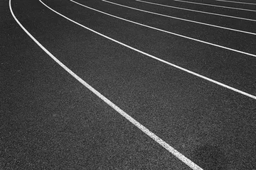 Papier Peint photo Chemin de fer White lines of stadium and texture of running racetrack black rubber racetracks in outdoor stadium are 8 track and green grass field,empty athletics stadium with track.