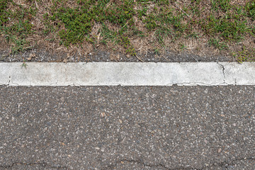 Obraz premium Asphalt road with stripes and green grass texture Background,empty copy space.