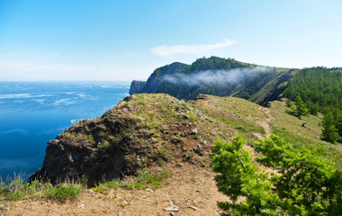 Baikal Lake in summer day. The path along the rocky shore off Olkhon Island. Tourist routes around...
