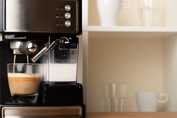 Hot cappuccino, lat in a cup. Prepare a refreshing, invigorating coffee in a glass transparent cup.