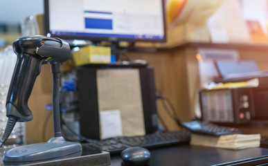 Close up barcode scanner in hand on blurred background,Inspection of goods in the warehouse,The concept of selling products in a supermarket,Spot focus,Copy space.