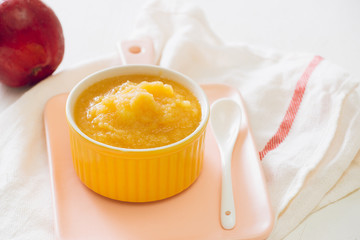 Homemade healthy baby food. Bowl of apple baby puree.
