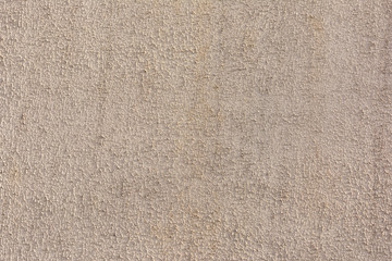 Texture of a rough plastered wall, close-up. Decorative brown putty. Blank background for website or layout.