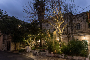 Glowing lights in the evening festively decorated for Christmas street in the Old City of Jerusalem in Israel