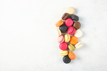 Different macaroons on a light background. Top view. Copy space