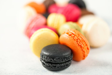 Different macaroons on a light background. Selective focus