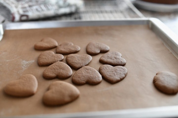 chocolate cookies in the form of heart, top view, pastry on the stove, dough preparation